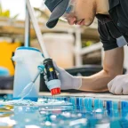 Top Swimming Pool Companies Improve Pool Water Flow for Better Hygiene Top Swimming Pool Companies technician improving pool water flow for better hygiene and circulation