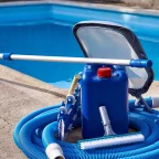 How Swimming Pool Cleaning Equipment Helps Maintain Pool Health Swimming Pool Cleaning Equipment set with vacuum hose, leaf skimmer, and cleaning tools near a poolside